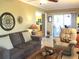 Comfortable living room featuring a sofa, recliner, and sliding glass doors to the screened patio at 13762 Sw 112Th Ter, Dunnellon, FL 34432