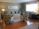 Comfortable living room features neutral tones, plush seating, and ample natural light for a relaxing ambiance at 13762 Sw 112Th Ter, Dunnellon, FL 34432