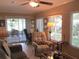 Cozy living room offers tile floors, a ceiling fan, access to the outdoors, and plenty of sunlight at 13762 Sw 112Th Ter, Dunnellon, FL 34432