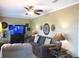 Relaxing living room with entertainment center, ceiling fan, and ample seating at 13762 Sw 112Th Ter, Dunnellon, FL 34432