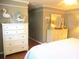 Relaxing bedroom with white dressers, a comfortable bed, and nautical-themed decor at 13762 Sw 112Th Ter, Dunnellon, FL 34432