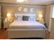 Serene bedroom with a king-size bed, matching nightstands, and coastal decor at 13762 Sw 112Th Ter, Dunnellon, FL 34432
