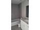 Updated bathroom featuring tiled shower over bath, granite countertop, and modern design at 17645 Sw 112Th Ln, Dunnellon, FL 34432