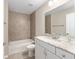 Stylish bathroom featuring tile surround, marble countertop, and modern fixtures at 17645 Sw 112Th Ln, Dunnellon, FL 34432