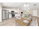 Modern kitchen with stainless steel appliances, a dining area, and a breakfast bar at 17645 Sw 112Th Ln, Dunnellon, FL 34432