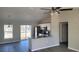 Open-concept living space with stainless appliances, gray floors and lots of natural light at 17645 Sw 112Th Ln, Dunnellon, FL 34432