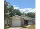 Single-Gathering home with attached garage and well-maintained lawn with mature trees at 2209 Ne 40Th Ave, Ocala, FL 34470