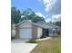 Charming single-story home with a brick-accented garage and well-manicured lawn at 2209 Ne 40Th Ave, Ocala, FL 34470