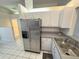 Well-lit kitchen with stainless steel refrigerator and white tile floors at 2209 Ne 40Th Ave, Ocala, FL 34470
