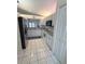 Efficient kitchen featuring white cabinetry, modern appliances, and tile flooring at 2209 Ne 40Th Ave, Ocala, FL 34470