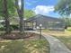 Community screened pool with lounge furniture and sidewalk entrance, surrounded by nature at 2209 Ne 40Th Ave, Ocala, FL 34470