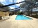 Community screened in pool with lounge furniture and nearby pool house for residents' enjoyment at 2209 Ne 40Th Ave, Ocala, FL 34470