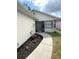 Inviting walkway with a screened porch and flowerbeds, enhancing curb appeal at 2209 Ne 40Th Ave, Ocala, FL 34470