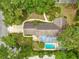 Aerial view of a home, showcasing a backyard pool, patio area, and lush landscaping at 2416 Se 15Th St, Ocala, FL 34471