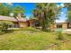 Expansive backyard features a sparkling pool, lush greenery, and mature trees at 2416 Se 15Th St, Ocala, FL 34471