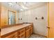 A well-lit bathroom featuring a long vanity and framed mirror at 2416 Se 15Th St, Ocala, FL 34471