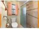 Bathroom features a modern shower, a toilet, and a window with privacy glass allowing for natural light at 2416 Se 15Th St, Ocala, FL 34471