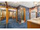 Well-lit bathroom with floral wallpaper, mirrored closet doors, and a walk-in shower at 2416 Se 15Th St, Ocala, FL 34471
