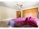 Bedroom featuring a ceiling fan, large closet, and plush bed with pillows at 2416 Se 15Th St, Ocala, FL 34471