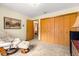 Comfortable bedroom with a recliner, large closet, and neutral carpet offers a relaxing and functional space at 2416 Se 15Th St, Ocala, FL 34471