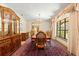 Dining room with a wooden table and a large cabinet, complemented by an ornate chandelier at 2416 Se 15Th St, Ocala, FL 34471
