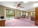 Large living room with sliding glass doors leading to outdoor pool area and comfortable furnishings at 2416 Se 15Th St, Ocala, FL 34471