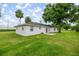 A well-maintained backyard featuring a green lawn and a patio area at 2521 Nw 45Th Pl, Ocala, FL 34475