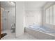 Bathroom with soaking tub, separate shower, and tiled floor; bright and clean at 2521 Nw 45Th Pl, Ocala, FL 34475