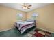 Comfortable bedroom featuring two windows, ceiling fan, and carpeted floors at 2521 Nw 45Th Pl, Ocala, FL 34475