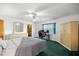 Comfortable bedroom with ceiling fan, dresser, wardrobe, and a dedicated desk area at 2521 Nw 45Th Pl, Ocala, FL 34475