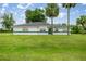 Charming single-story home with lush green lawn and well-maintained landscaping, offering curb appeal at 2521 Nw 45Th Pl, Ocala, FL 34475