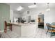 Kitchen with bar seating area, stainless appliances, skylight, and adjacent dining area at 2521 Nw 45Th Pl, Ocala, FL 34475