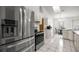 Bright kitchen features stainless steel appliances, white cabinetry, and tiled flooring at 2521 Nw 45Th Pl, Ocala, FL 34475