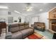 Inviting living room with a brick fireplace, ceiling fan, and an open layout, for relaxation and gatherings at 2521 Nw 45Th Pl, Ocala, FL 34475