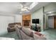 Comfortable living area with brick fireplace and a ceiling fan, creating a welcoming atmosphere at 2521 Nw 45Th Pl, Ocala, FL 34475