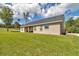 Spacious yard and home exterior featuring lush lawn and a covered patio area for outdoor enjoyment at 2525 Sw 7Th Ave, Ocala, FL 34471