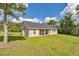 Expansive backyard view featuring lush green lawn and home exterior in a serene setting at 2525 Sw 7Th Ave, Ocala, FL 34471