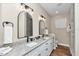 The bathroom features a double sink vanity with granite countertops and modern fixtures at 2525 Sw 7Th Ave, Ocala, FL 34471