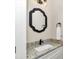 Powder room with white cabinets, granite countertops, and modern mirror at 2525 Sw 7Th Ave, Ocala, FL 34471