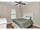 Bedroom with wood-look flooring, ceiling fan, and a window overlooking the backyard at 2525 Sw 7Th Ave, Ocala, FL 34471