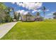 View of front home exterior, showing driveway and landscaping against sunny skies at 2525 Sw 7Th Ave, Ocala, FL 34471