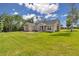 Well-maintained exterior of home with a large front yard, stone details and manicured landscaping at 2525 Sw 7Th Ave, Ocala, FL 34471