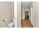 Hallway leading to a bathroom, featuring wood-look tile flooring at 2525 Sw 7Th Ave, Ocala, FL 34471