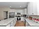 Bright kitchen featuring white cabinets, stainless steel appliances, and granite countertops at 2525 Sw 7Th Ave, Ocala, FL 34471