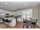 Modern kitchen with white cabinetry, stainless steel appliances, granite countertops, and a breakfast bar at 2525 Sw 7Th Ave, Ocala, FL 34471