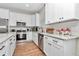 Stylish kitchen with white cabinetry, stainless steel appliances, and wood-look tile flooring at 2525 Sw 7Th Ave, Ocala, FL 34471