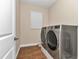 Laundry room with modern washer and dryer, tile flooring, and a window at 2525 Sw 7Th Ave, Ocala, FL 34471