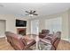 Relaxing living room featuring a fireplace, wood-look tile flooring, and ample seating, creating a cozy atmosphere at 2525 Sw 7Th Ave, Ocala, FL 34471