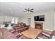 Open-concept living room adjacent to the kitchen, featuring wood-look tile flooring, a fireplace, and comfortable seating at 2525 Sw 7Th Ave, Ocala, FL 34471