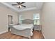 Main bedroom featuring a tray ceiling, wood-look tile flooring, and ensuite bathroom at 2525 Sw 7Th Ave, Ocala, FL 34471